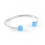 Xtinctio - Bangle Sterling Silver dipped Platinum and Blue Chalcedony stone. Imbued with the spirit of the Ocean and serving as a constant reminder that in this age of extinction, we are all connected to every living thing. Our partner in Ocean Conservation is The Coral Reef Restoration.