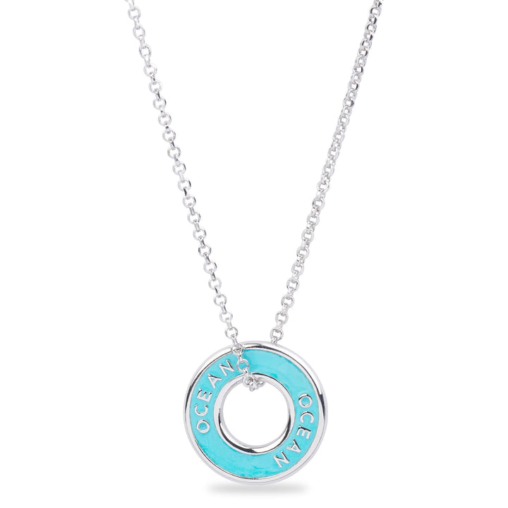Xtinctio - Necklace This Etruscan pendant is hand made in Italy by a third generation goldsmith and engraved with the word "Ocean" turquoise enamel.  The pendant hangs on a 925 sterling silver necklace and represents your commitment to protecting the Ocean. 