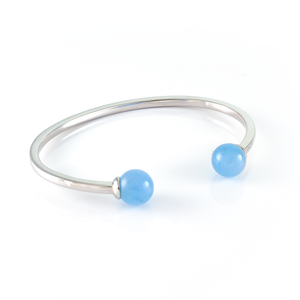 Xtinctio - Bangle Sterling Silver dipped Platinum  and Blue Chalcedony stone.  Imbued with the spirit of the Ocean and serving as a constant reminder that in this age of extinction, we are all connected to every living thing.  Our partner in Ocean Conservation is The Coral Reef Restoration.  